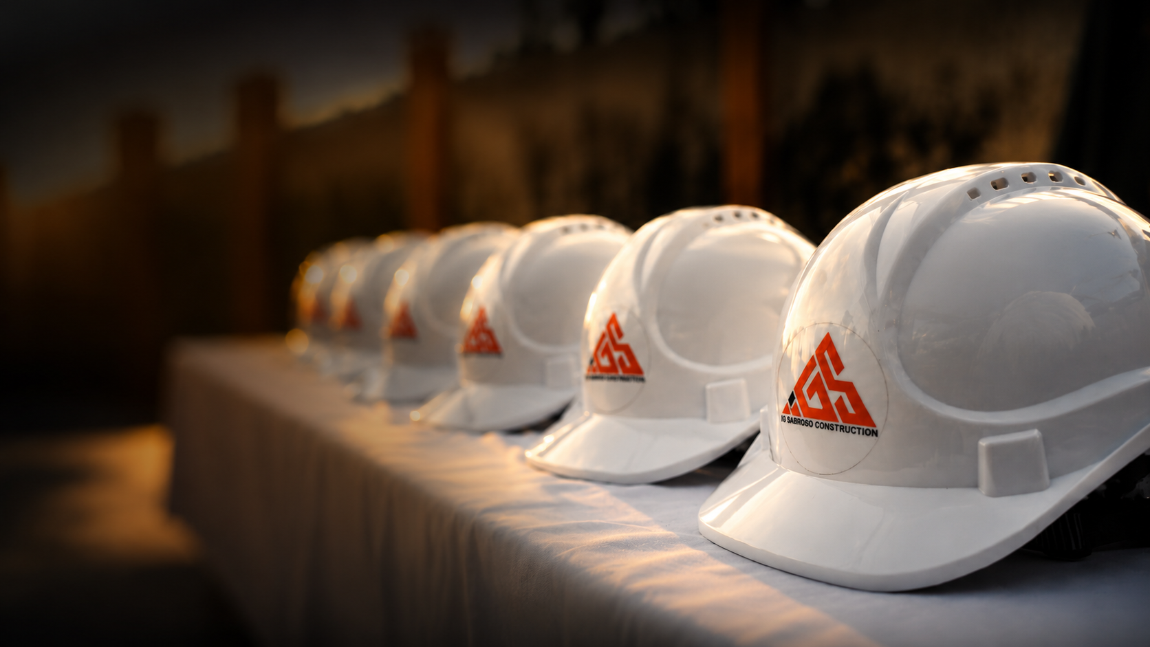 IG Sabroso Construction crew safety helmets lined up at golden hour